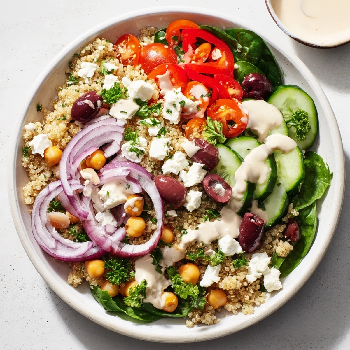 Healthy Mediterranean Dinner Grain Bowl with spinach, red bell pepper, and red onion, ready to enjoy for a quick vegetarian meal.