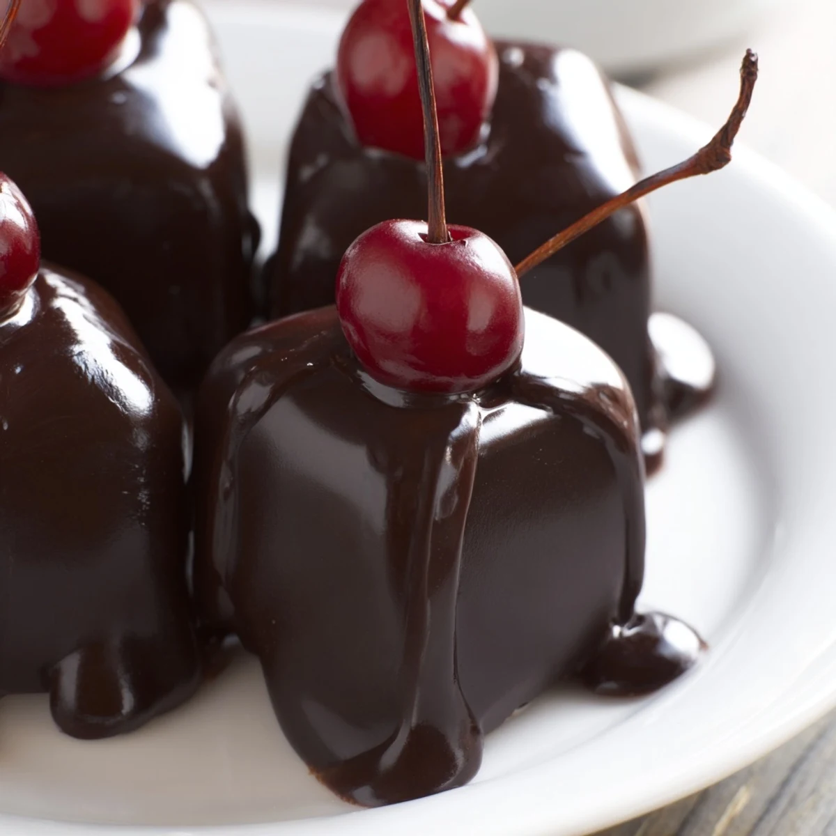 Freshly dipped Chocolate Covered Cherries with Fondant Center arranged on parchment for gifting.