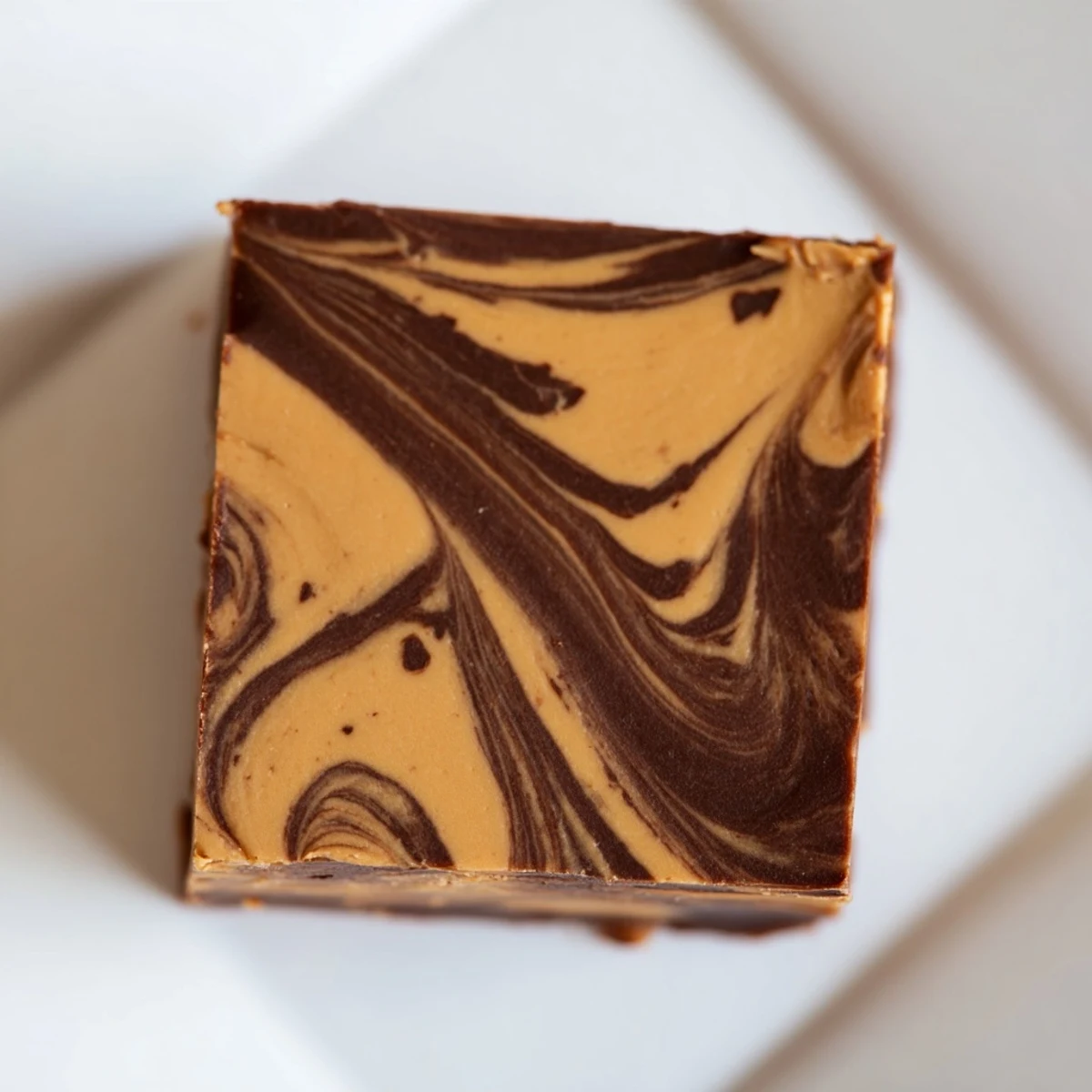 Close up of sliced Chocolate Peanut Butter Fudge pieces with visible peanut butter swirls, perfect for a sweet party treat.