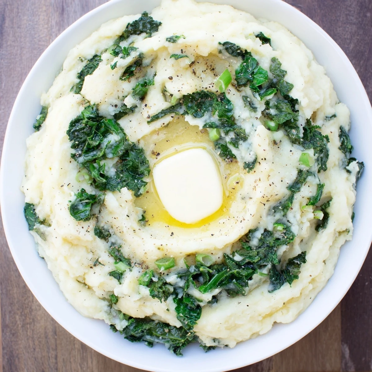 Creamy Irish Colcannon with Kale and Butter piled high on a warm dinner plate.