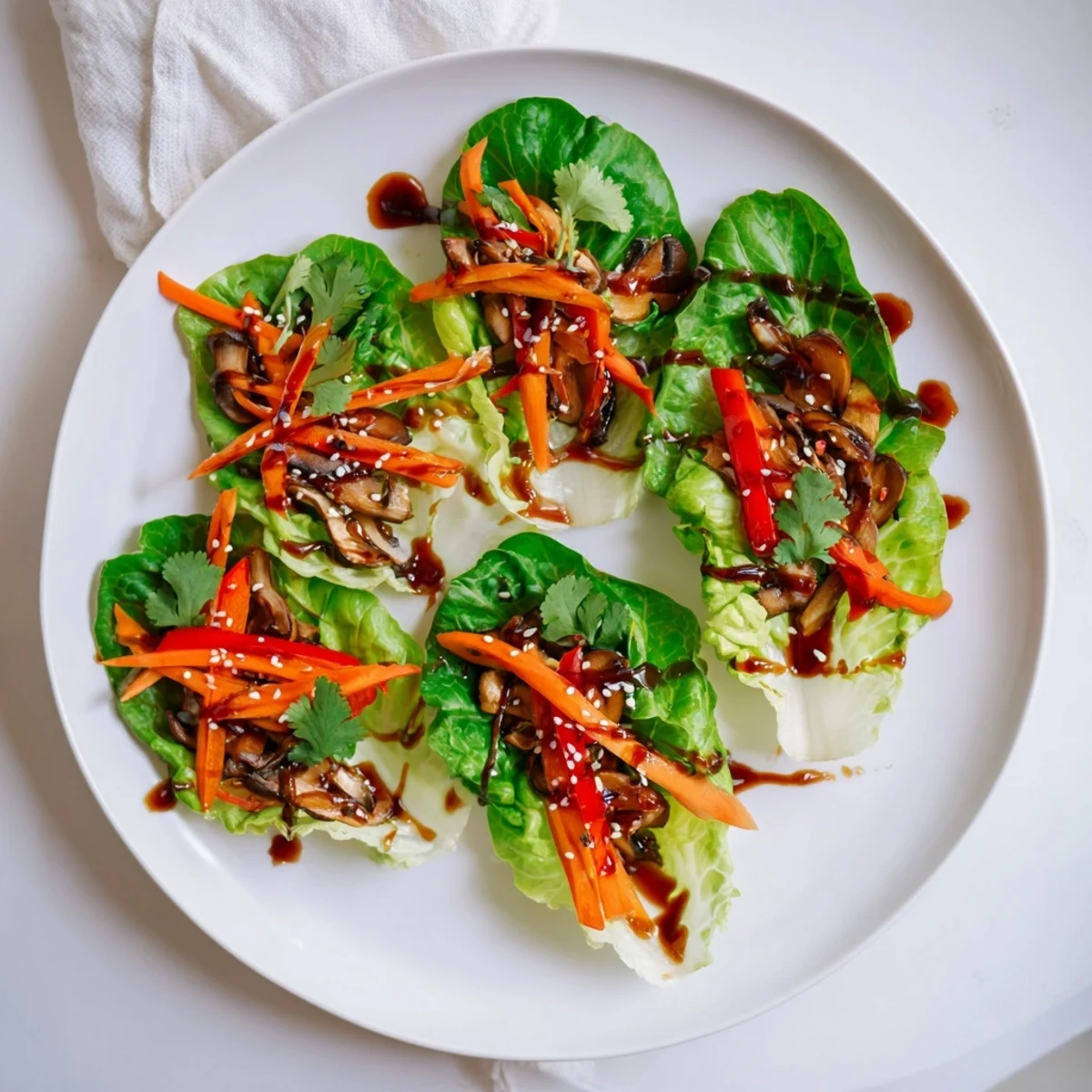 Hot shiitake mushroom lettuce wraps served with fresh herbs and sesame seeds.