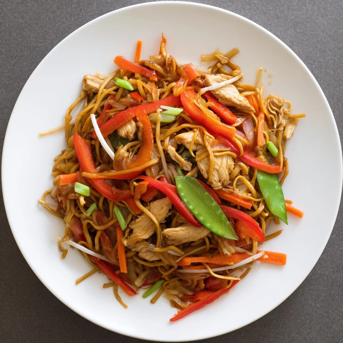 Tender chicken, crisp vegetables, and noodles in savory sauce for Chicken Chow Mein.