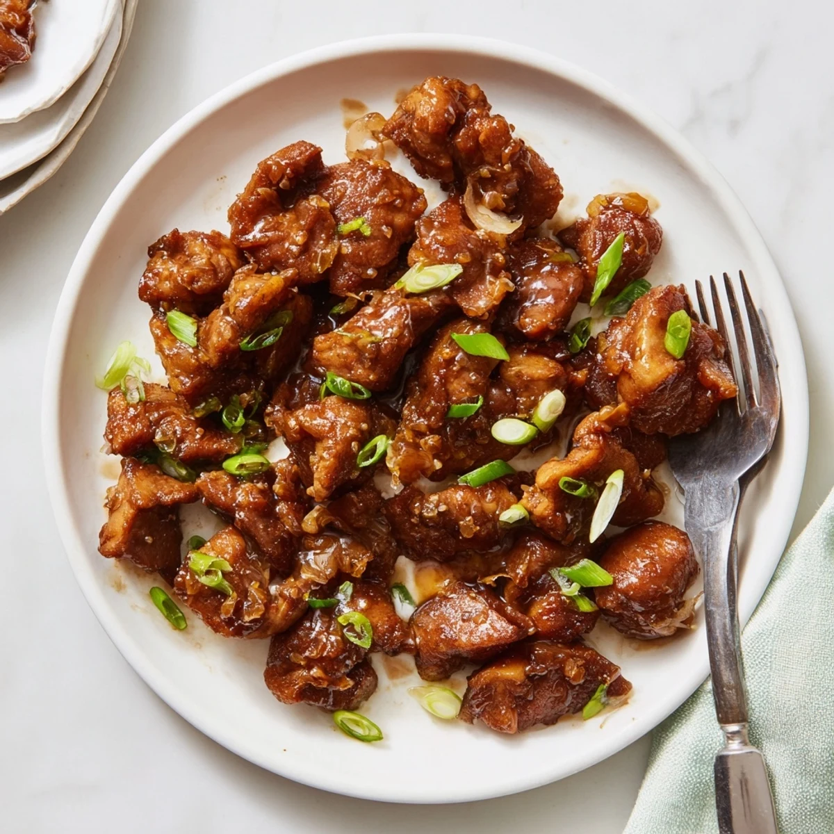 Golden glazed Mongolian chicken pieces coated in thick sweet and savory brown sugar sauce