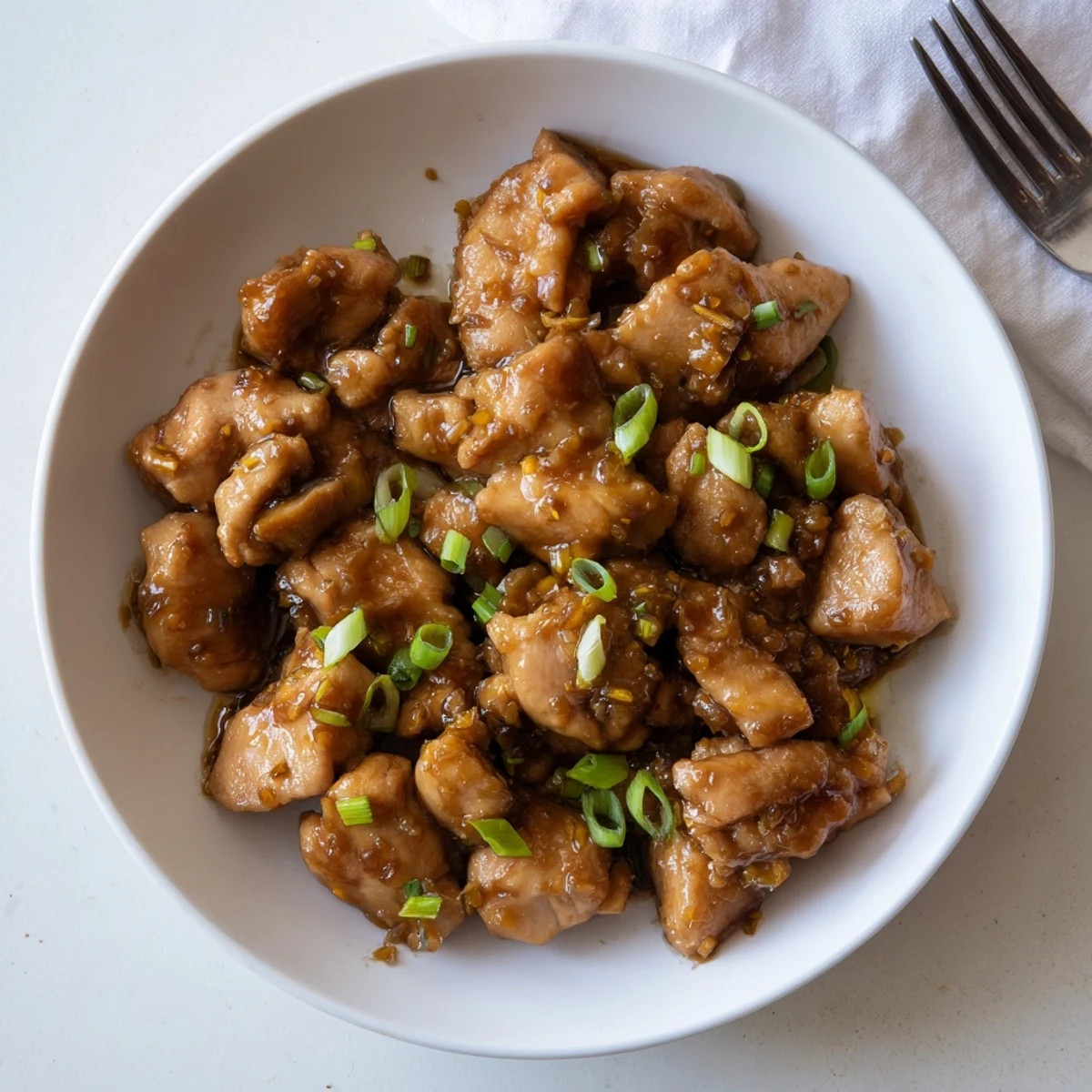 Easy homemade Mongolian chicken served steaming hot over fluffy white rice with caramelized glaze