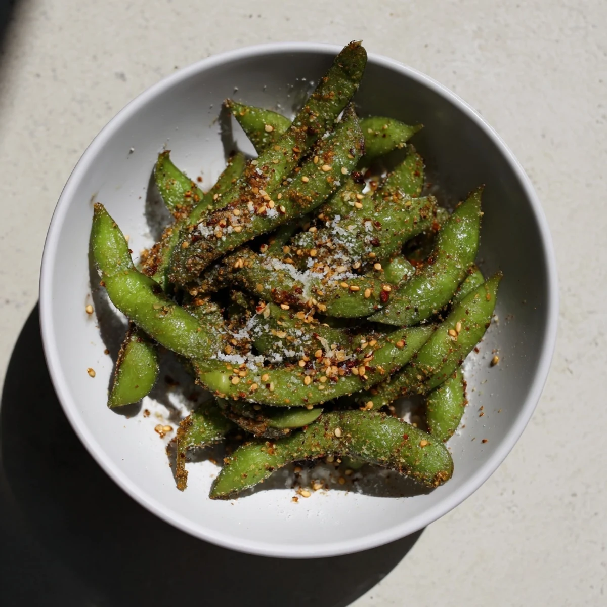Golden air fryer edamame pods lightly crisped and seasoned with sea salt and garlic powder