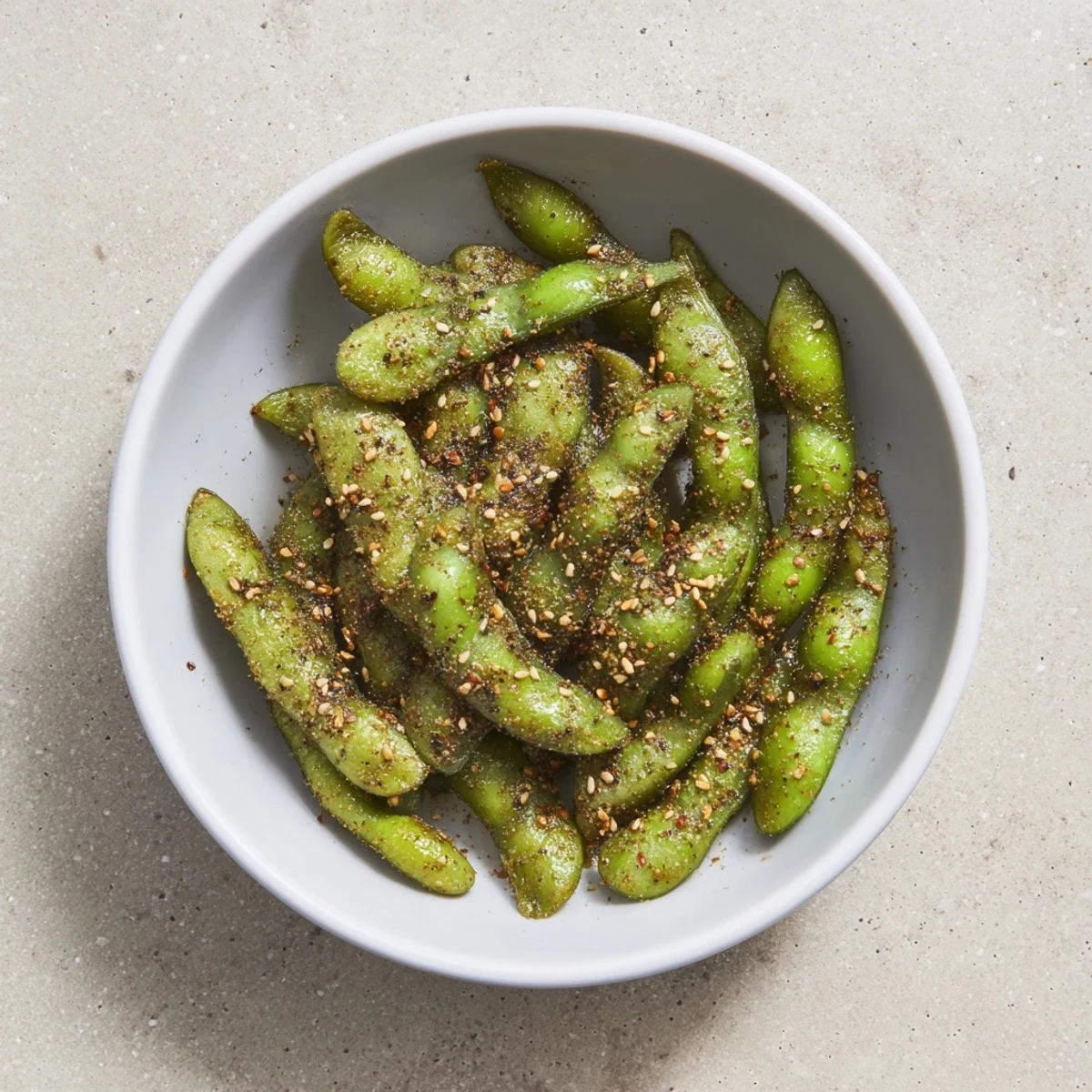 Vibrant green edamame air fried to perfection with paprika and olive oil coating