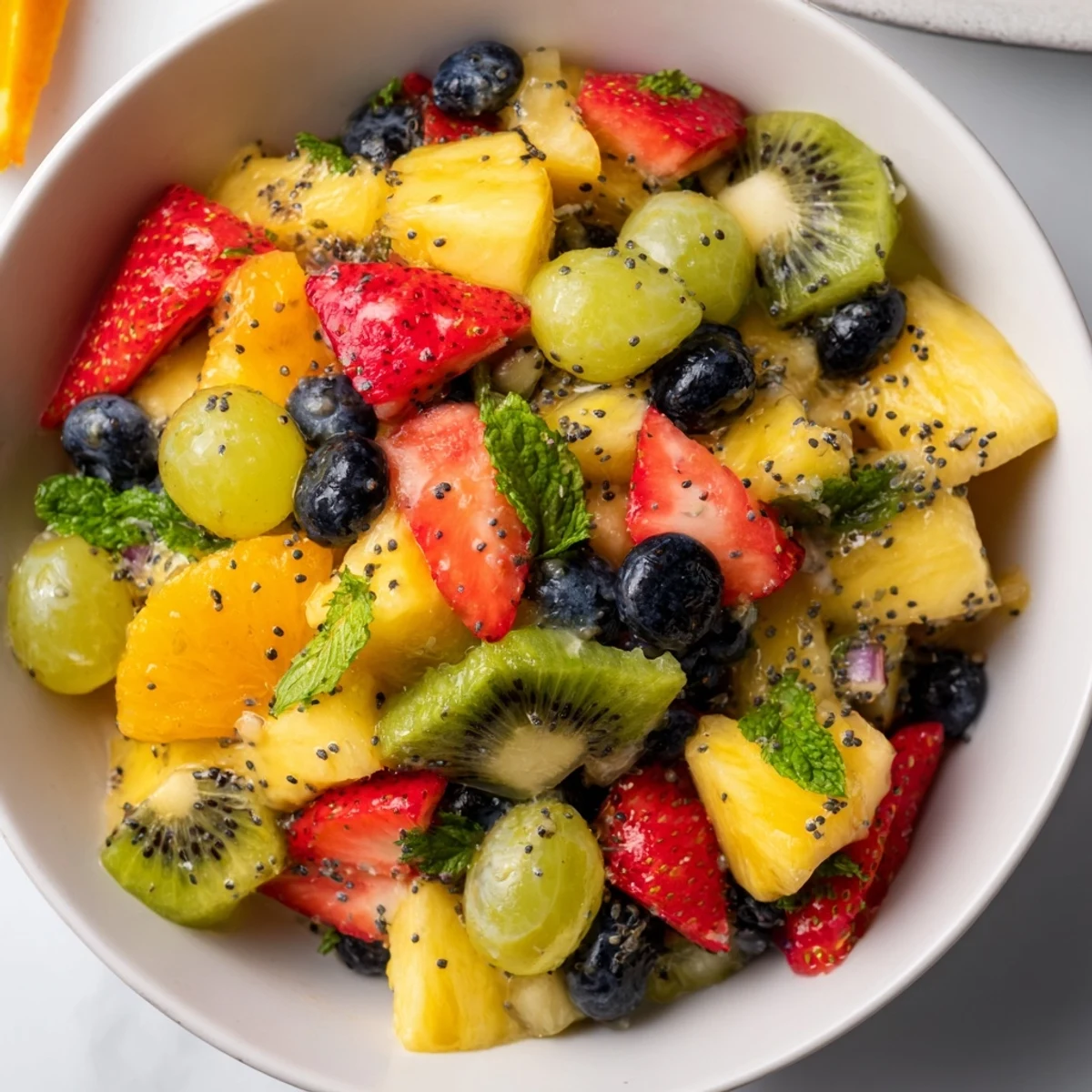 Festive Easter fruit salad displaying juicy mixed fruits in a glass serving bowl with fresh mint