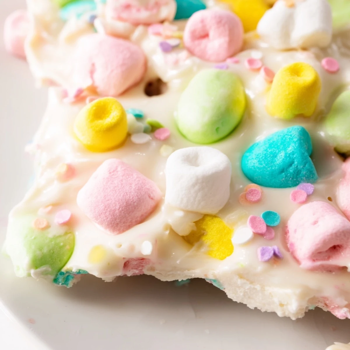 Festive Easter marshmallow bark featuring melted white chocolate with pastel marshmallows and crunchy chocolate egg pieces