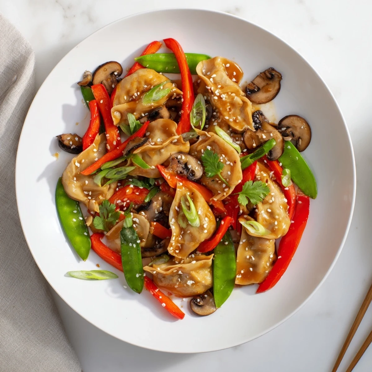 Golden potsticker stir fry with colorful crisp vegetables in savory glossy sauce