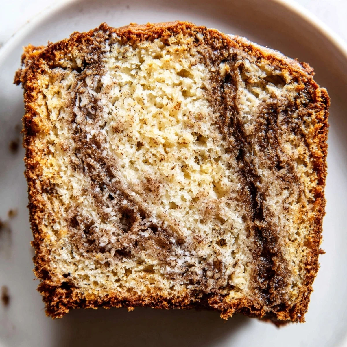 Moist Cinnamon Sugar Swirl Banana Bread with marbled cinnamon ribbons peeking through tender golden brown crumb