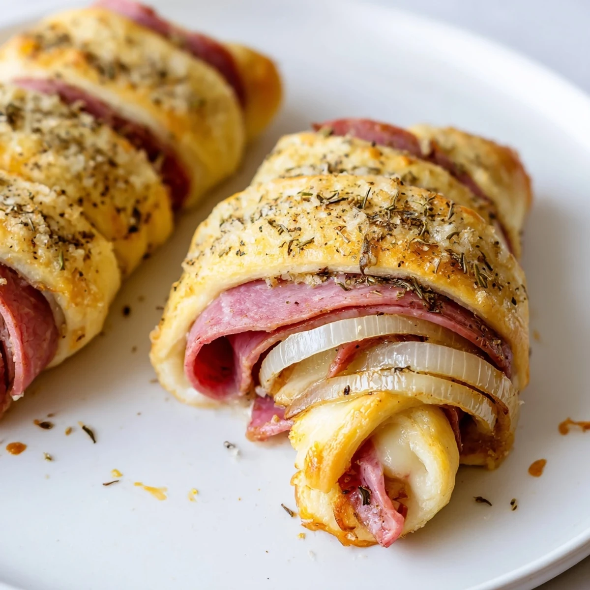 Golden beef and cheese French dip roll ups with melty provolone and tender roast beef inside