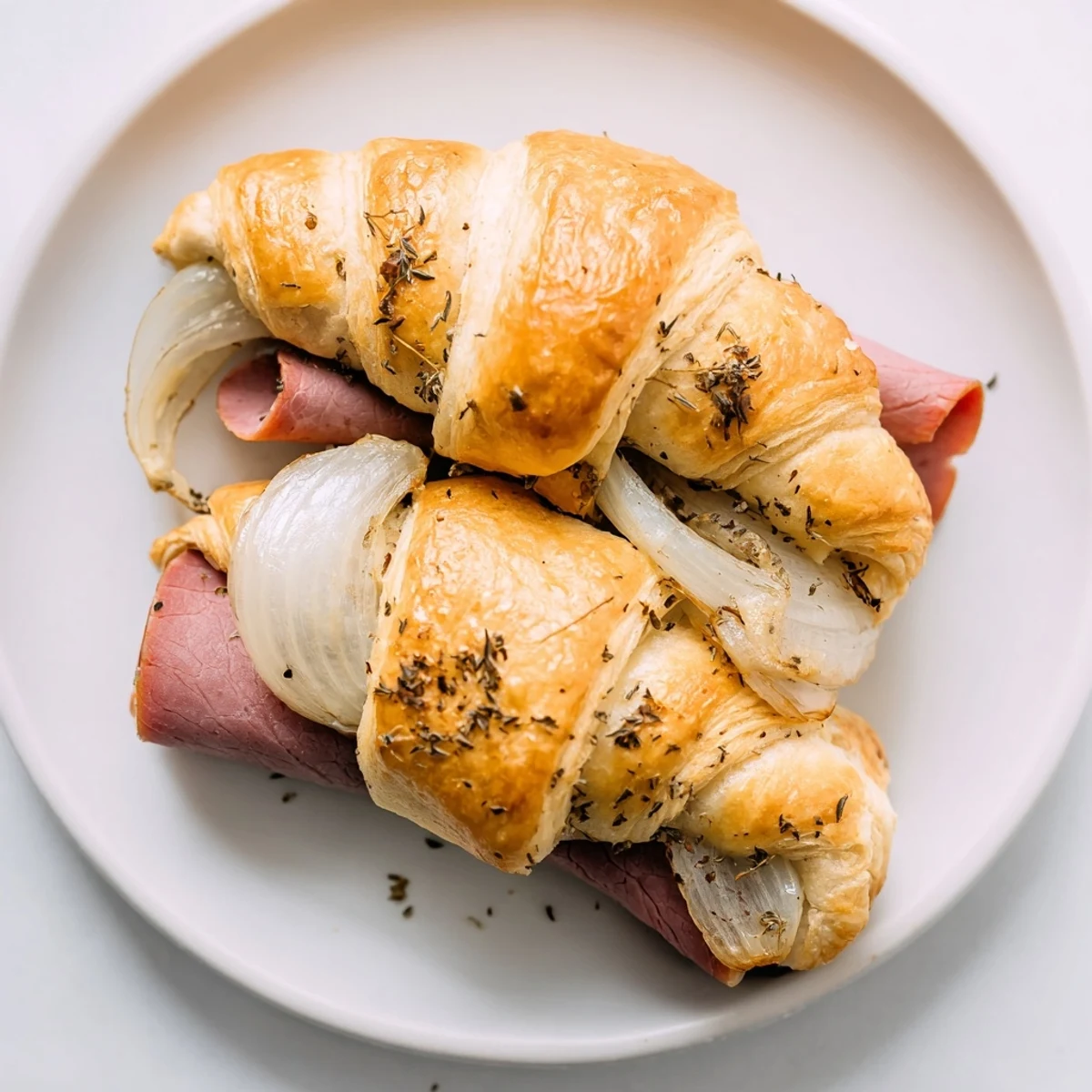 Beef and cheese French dip roll ups served hot with savory au jus for dipping