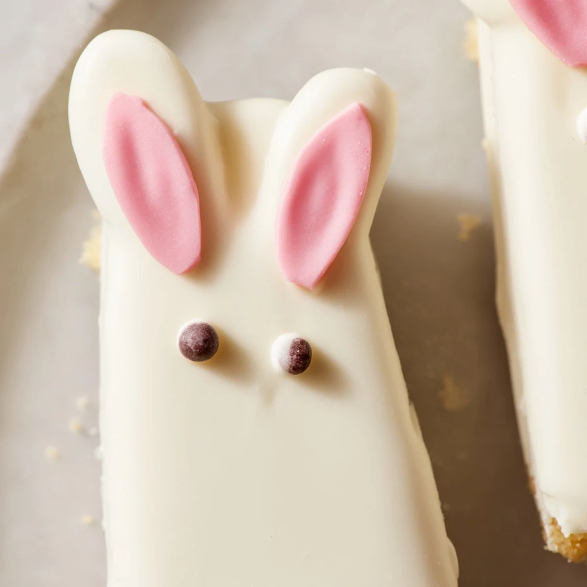 Creamy white chocolate bunny cakesicles decorated with sprinkles for a sweet Easter celebration