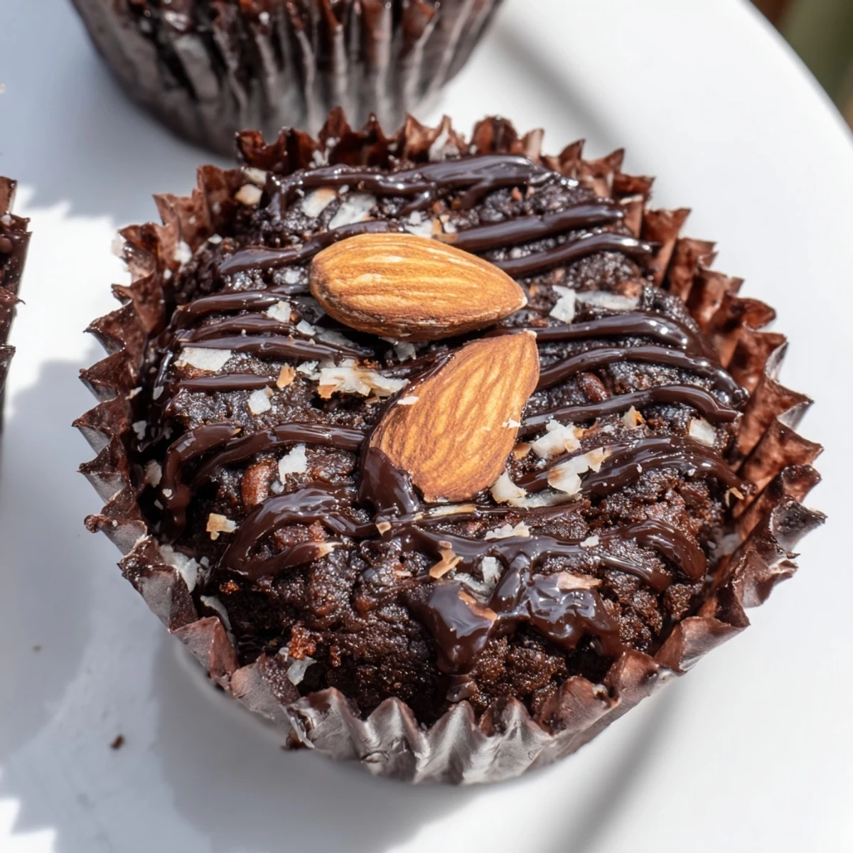 Decadent flourless almond joy cupcakes with gooey coconut centers and glossy melted chocolate crowns