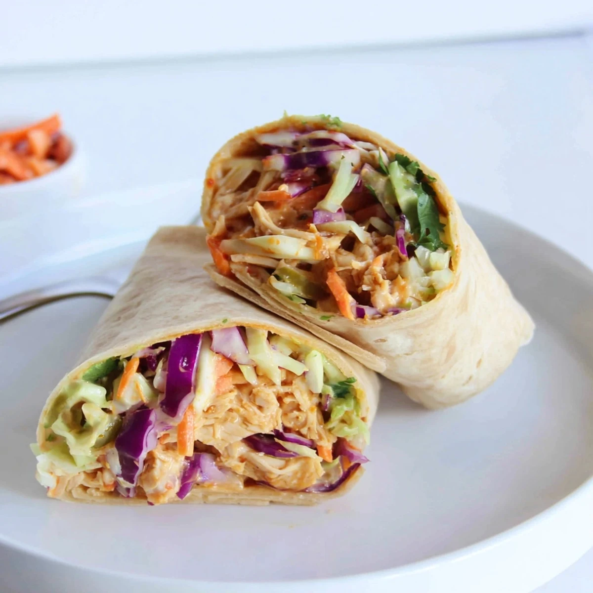 Bbq Chicken Coleslaw Wraps halved to show smoky chicken and crunchy slaw  