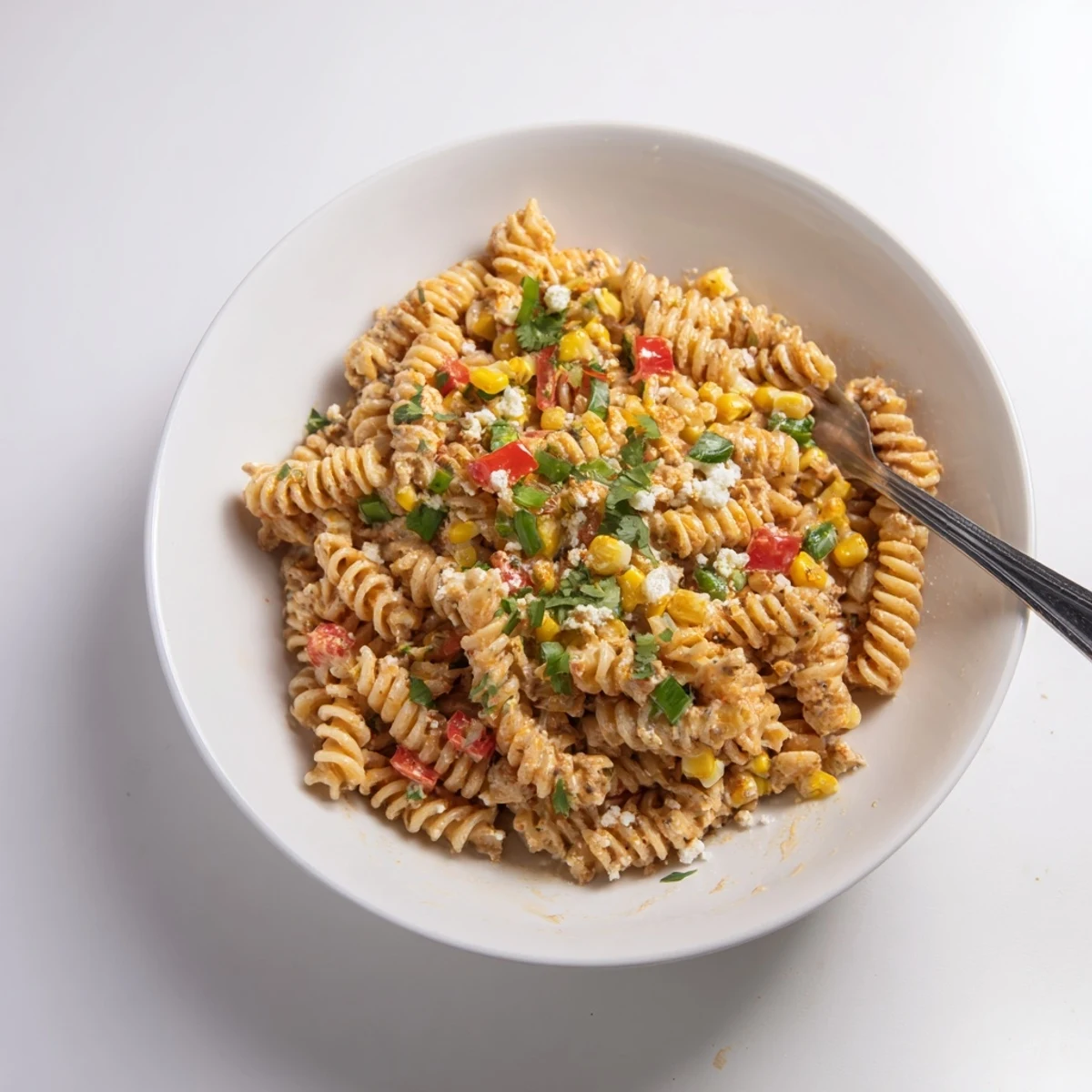 Street Corn Pasta Salad with charred corn, tangy lime, creamy Cotija finish