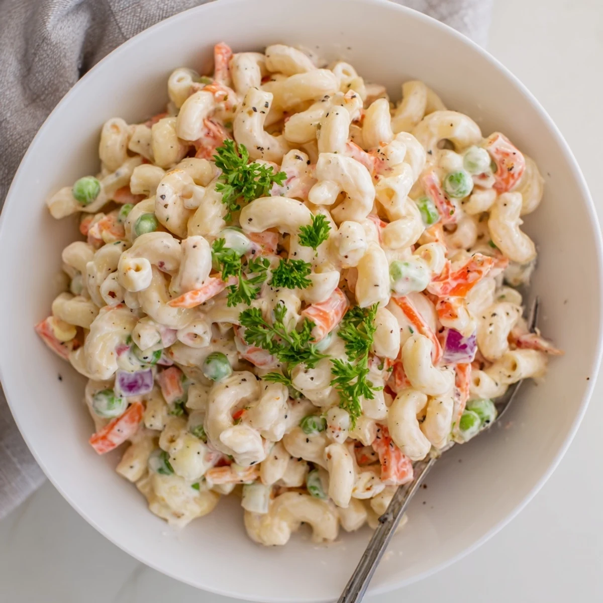 Creamy macaroni salad with crisp celery and peppers, chilled for picnics.