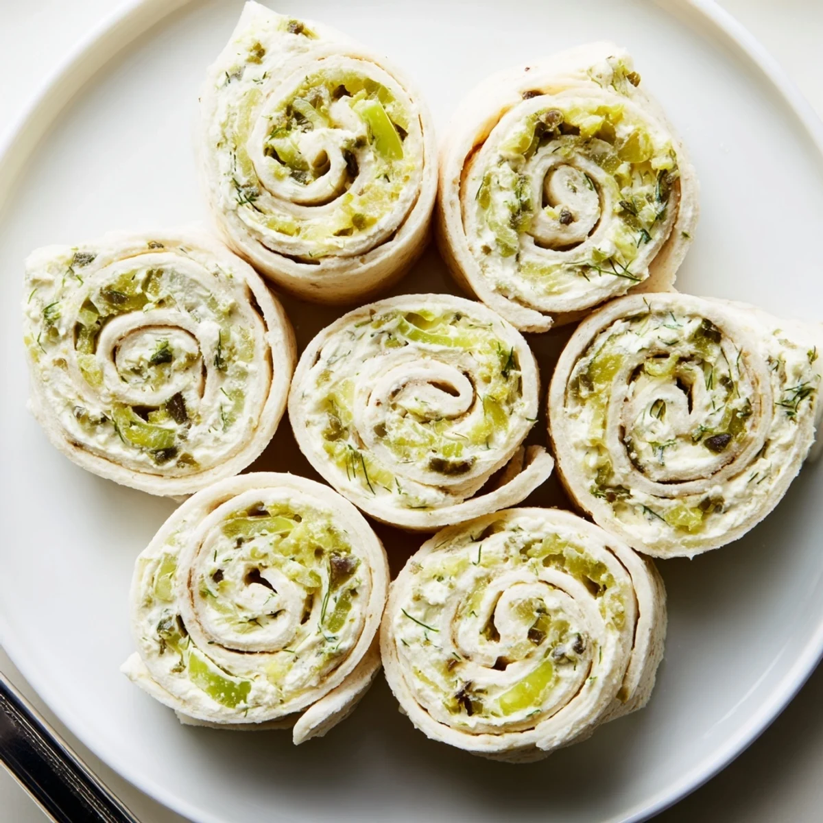 A tray of Pickle Dip Pinwheels with tangy pickles and fresh dill