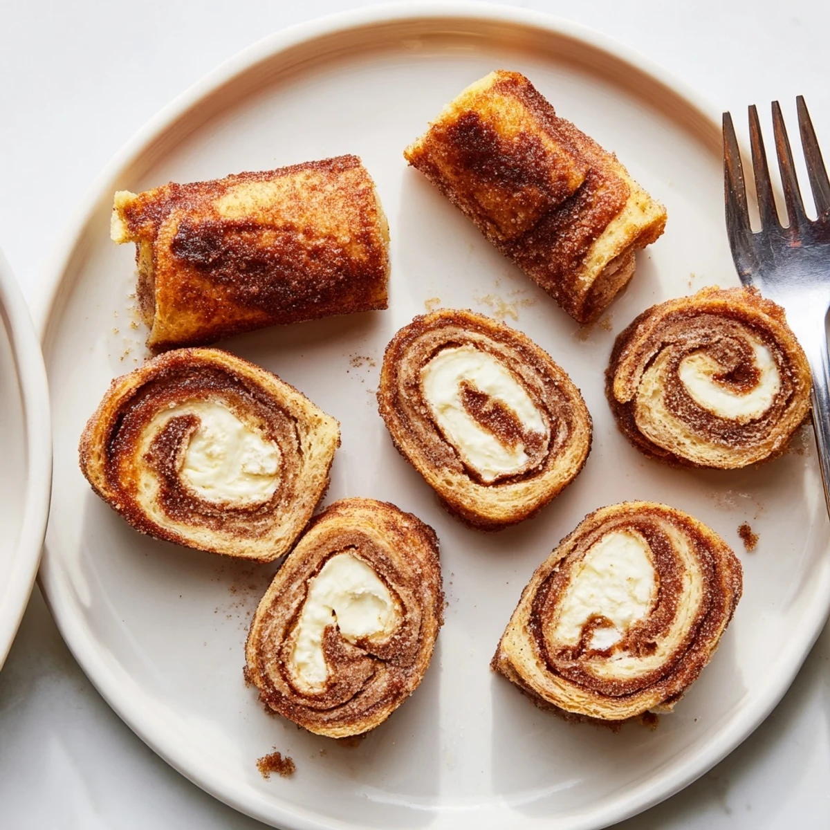 Cinnamon Roll French Toast Roll Ups golden, cinnamon-crusted, served with warm maple syrup