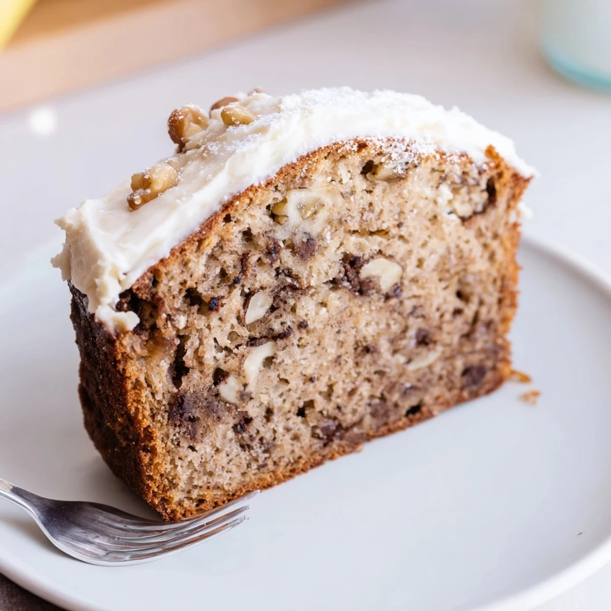 Sliced Banana Bread Cake Recipe served with vanilla ice cream, cinnamon aroma.