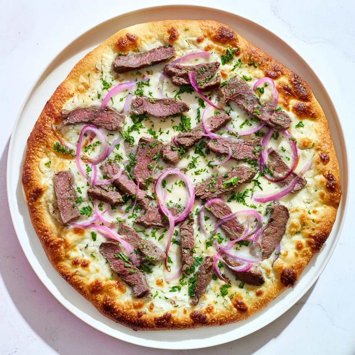 Sliced Beef Alfredo Pizza on golden crust with red onion and provolone cheese topping