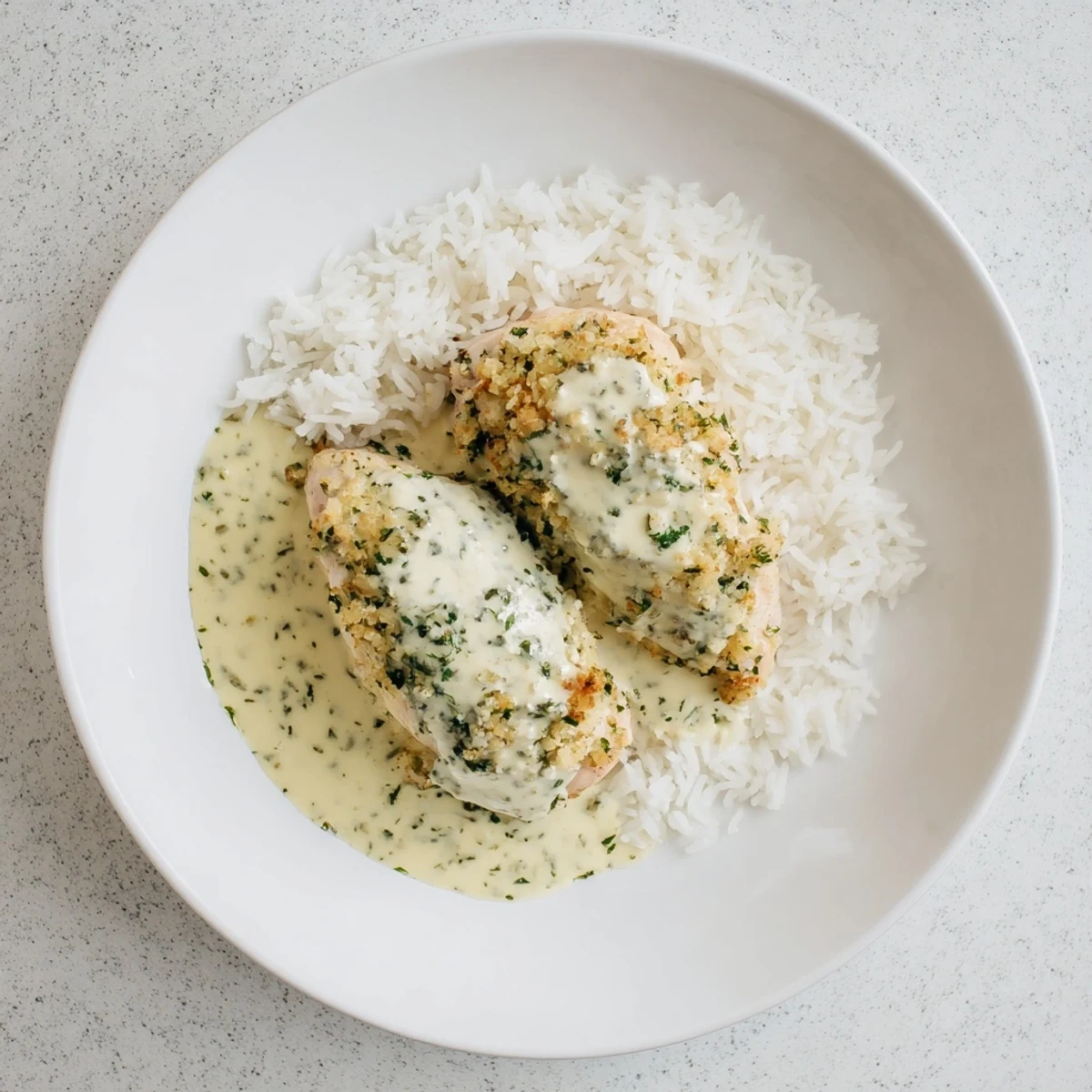 Herb seasoned chicken thighs swimming in rich creamy garlic sauce served over a bed of rice