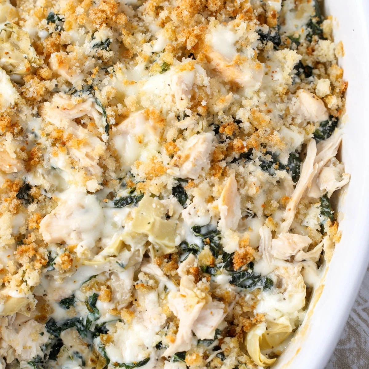 Hearty high protein spinach and artichoke chicken casserole ready for family dinner serving
