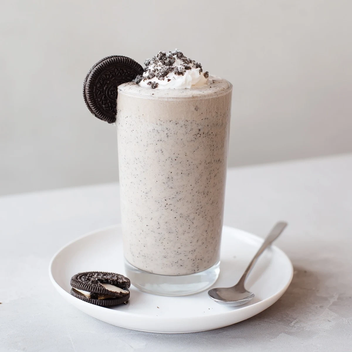 Frosty Cookies And Cream Protein Shake in tall glass, with banana creaminess