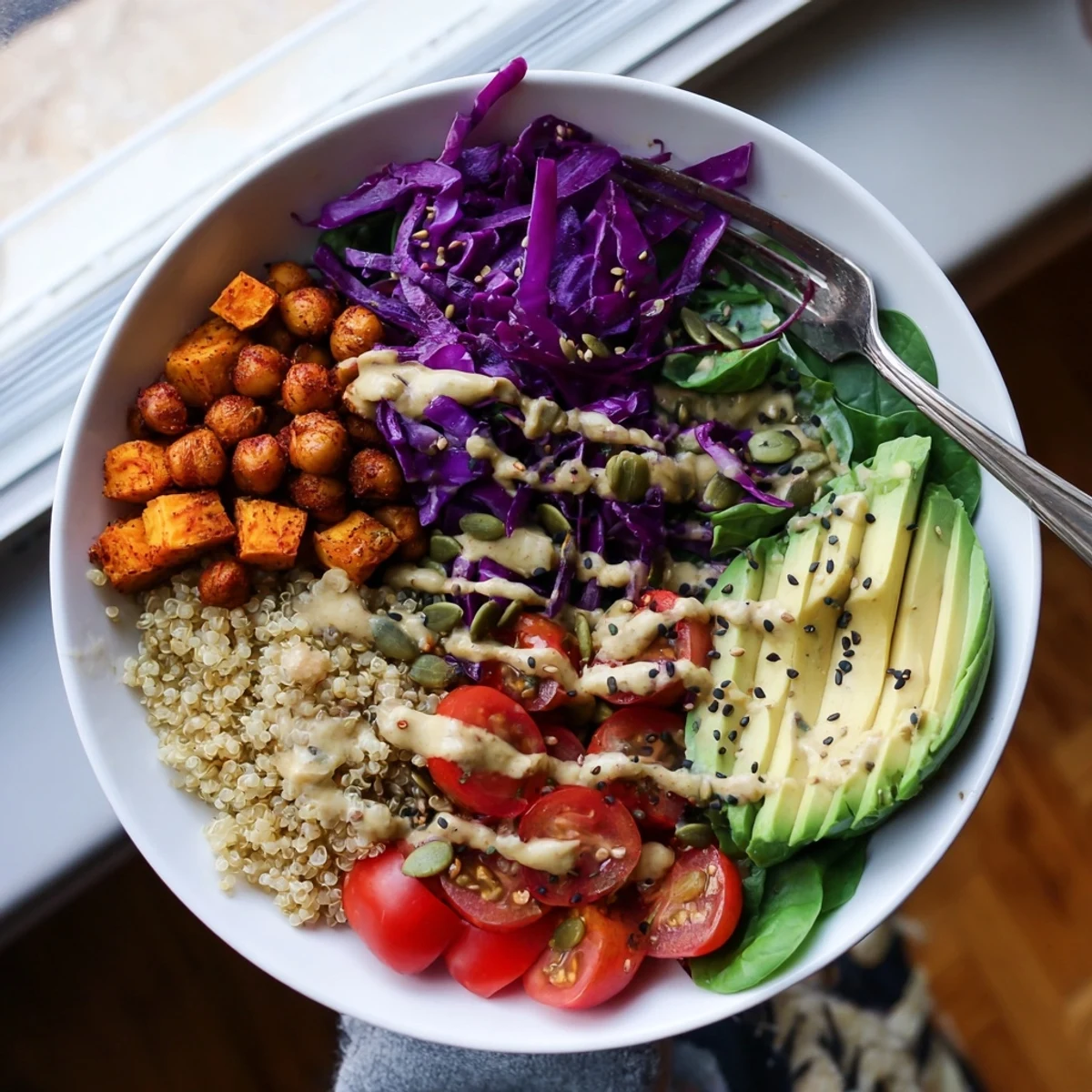 Colorful Buddha Bowl with roasted sweet potatoes, crispy chickpeas, and creamy tahini dressing