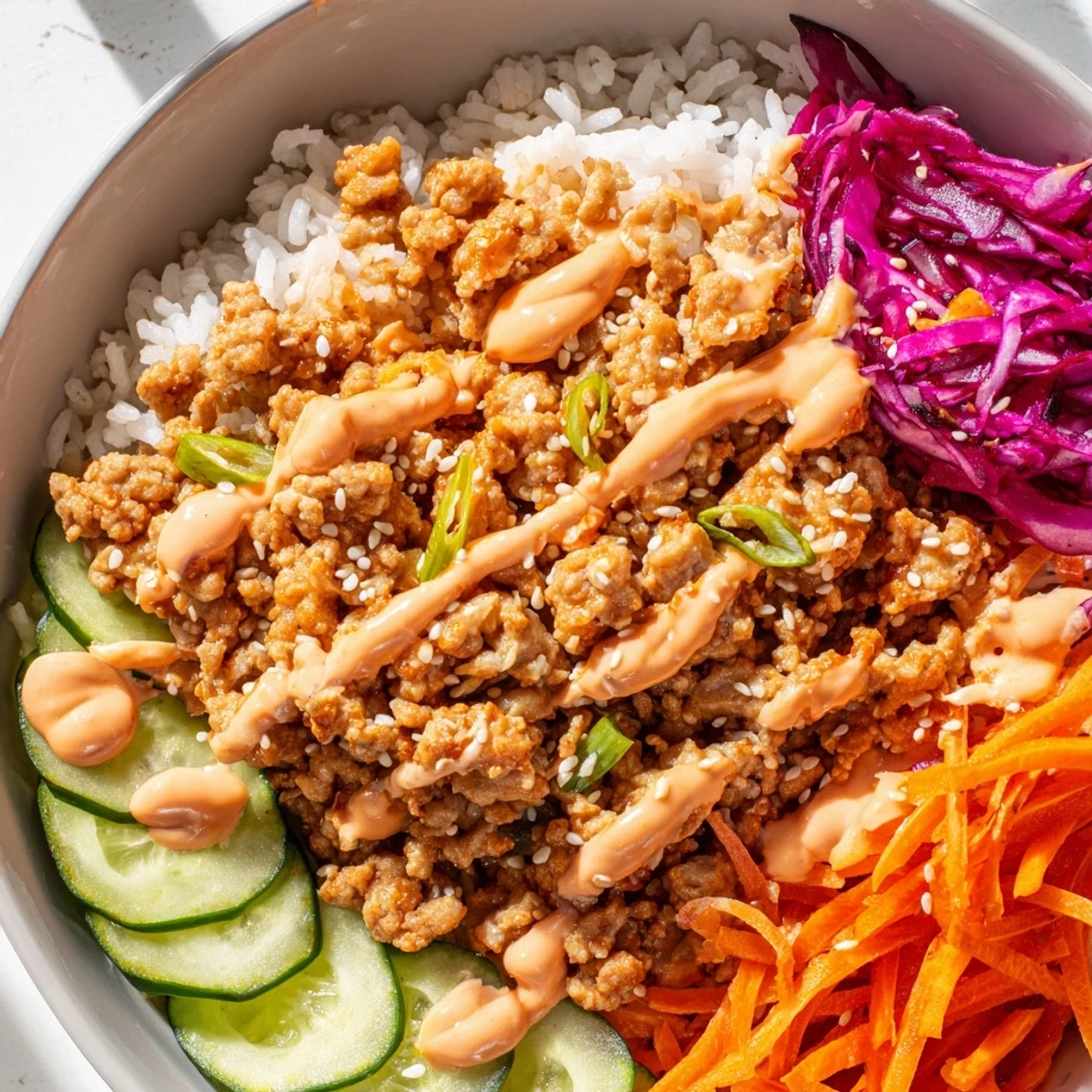 Ground Turkey Rice Bowls topped with vibrant veggies and drizzled Bang Bang Sauce