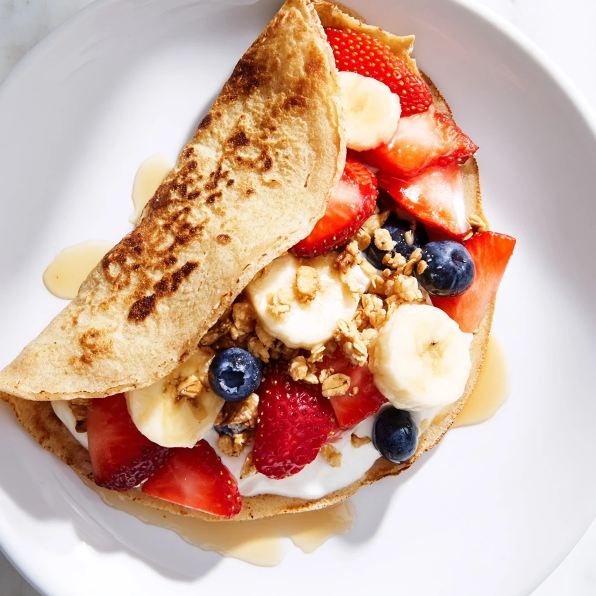 Fluffy pancake tacos folded around creamy Greek yogurt and vibrant blueberry granola filling