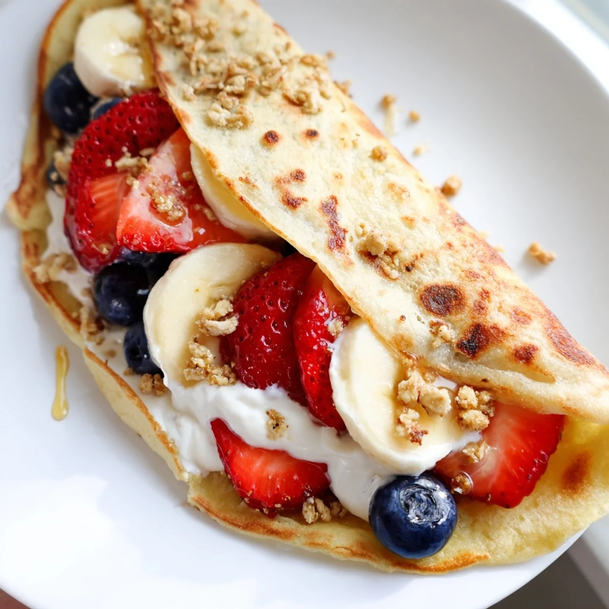 Warm pancake tacos filled with scrambled eggs and melted cheddar on a breakfast platter