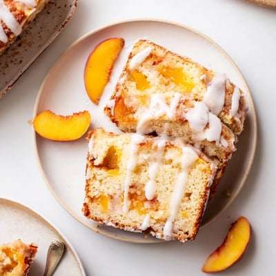 Buttery pound cake studded with juicy peaches and warm cobbler spices