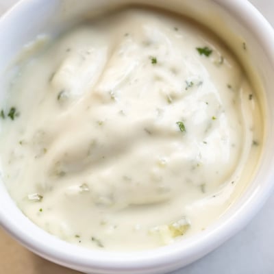 Rich homemade Mexican white sauce drizzled over crispy tacos and grilled seasoned chicken